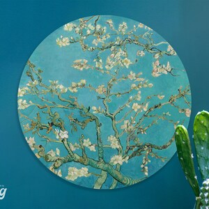 May include: A circular wall decal featuring a painting of a blooming almond tree with white flowers against a blue sky. The painting is in the style of Vincent van Gogh.