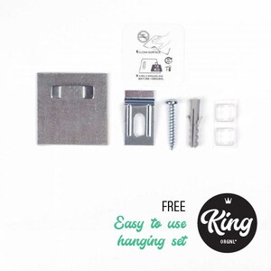 May include: A silver metal hanging system with a screw, a plastic anchor, and a metal plate. The system is labelled "FREE Easy to use hanging set" and "King ORGN'L".