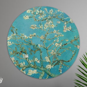 May include: A round wall art print featuring a painting of a blooming almond tree with white flowers against a blue sky. The painting is in the style of Vincent van Gogh.