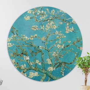 May include: A round wall decoration featuring a painting of a blossoming almond tree with white flowers against a blue background. The painting is in the style of Vincent van Gogh.