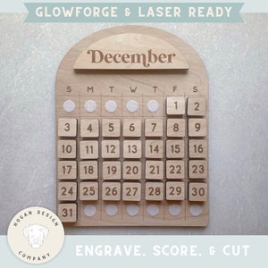 May include: A wooden calendar with the word "December" engraved at the top. The calendar has a grid of squares with numbers 1 through 31 engraved on them. The calendar is designed for laser cutting and engraving.