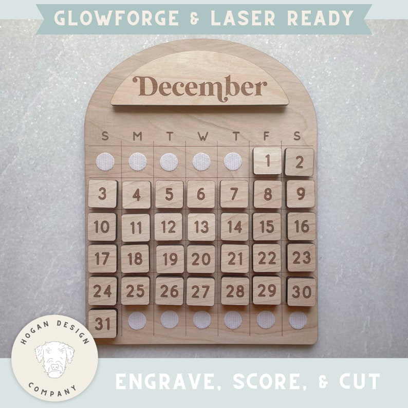 May include: A wooden calendar with the word "December" engraved at the top. The calendar has a grid of squares with numbers 1 through 31 engraved on them. The calendar is designed for laser cutting and engraving.