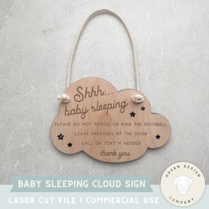 May include: A wooden cloud-shaped sign with the text "Shhh... baby sleeping" and instructions for visitors. The sign is laser cut and has a rope for hanging. The text reads: "Please do not knock or ring the doorbell. Leave packages at the door. Call or text if needed. Thank you."
