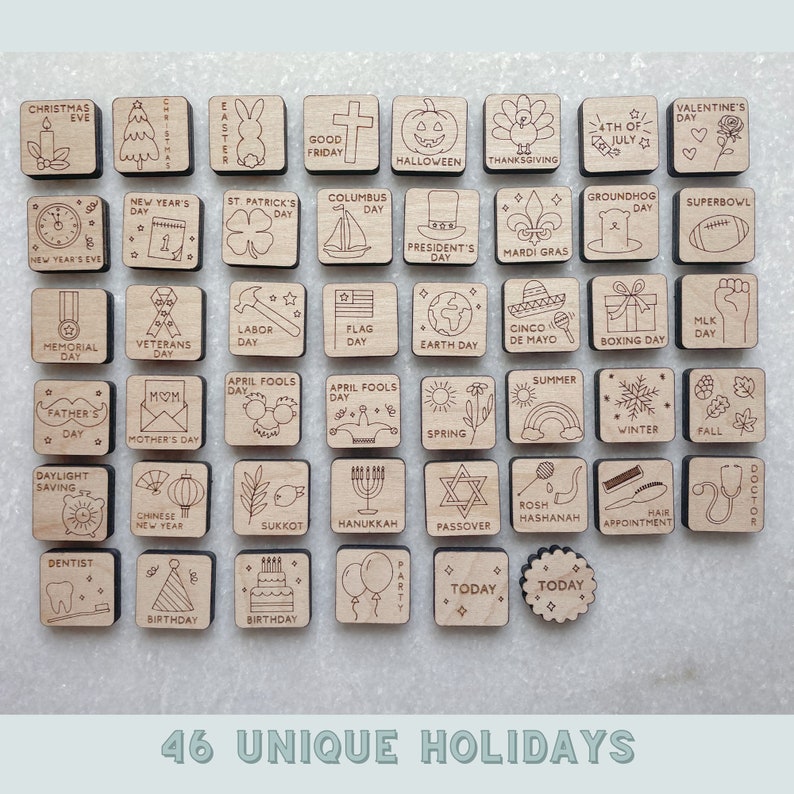 May include: A set of 46 wooden squares with different holiday icons and text. The squares are arranged in a grid pattern and are all made of light brown wood. The icons are all black and white and include images of Christmas trees, pumpkins, hearts, flags, and more. The text on the squares includes holiday names such as "Christmas Eve", "Halloween", "Valentine's Day", and "4th of July".