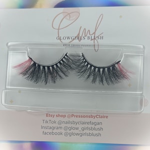 May include: A pair of false eyelashes with pink tips in a clear plastic case. The case has the text "Glowgirls Blush" on it. The text "Etsy shop @PressonsbyClaire TikTok @nailsbyclairefagan Instagram @glow_girlsblush facebook @glowgirlsblush" is printed below the case.