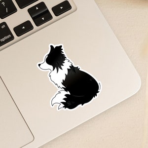 May include: Black and white border collie dog sticker on a silver laptop.