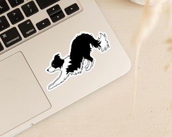 May include: Black and white border collie dog sticker with a white background. The dog is in a running pose with its tongue out.