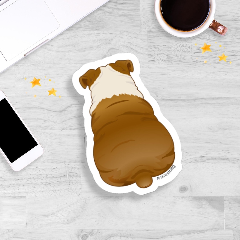 May include: A sticker featuring a cartoon illustration of a bulldog from the rear. The dog is primarily brown with a white patch on its back and head. The sticker is on a white background.