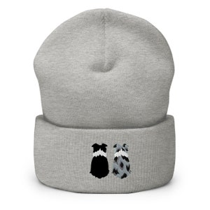 May include: Grey beanie with an embroidered design of two border collies sitting back to back. One collie is black and white, the other is blue merle.