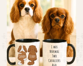 May include: Two Cavalier King Charles Spaniel dogs sit behind two white mugs with black rims and handles. One mug has illustrations of the dogs and the names "Candy" and "Teddy". The other mug reads "I WAS NORMAL TWO CAVALIERS AGO."