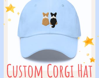 May include: A light blue baseball cap with an embroidered design of two corgis sitting back to back. The corgi on the left is brown and white, and the corgi on the right is black and white. The text "CUSTOM CORGI HAT" is printed in red on a white background below the image.