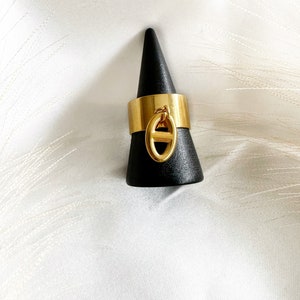 Adjustable stainless steel ring with golden charm