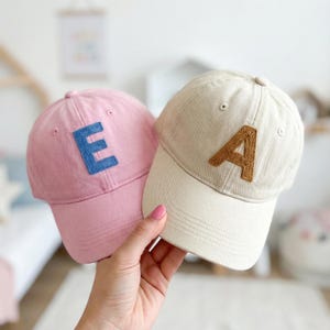 May include: A set of three ceramic mugs with a speckled, matte finish. The mugs are in shades of cream, light gray, and dark gray. Each mug has a simple, minimalist design, perfect for coffee or tea.