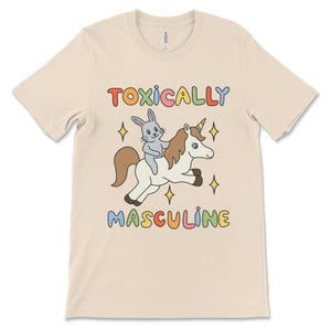 Funny graphic tee featuring the phrase "Toxically Masculine," delivering an ironic and satirical take on toxic masculinity.