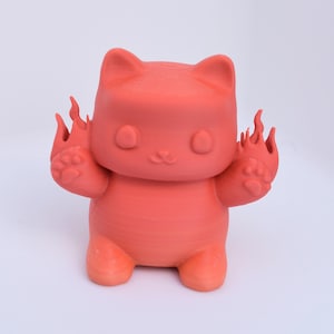 May include: A bright orange 3D printed cat figurine with flames coming out of its paws. The cat has a cute, cartoon-like face with large eyes and a small mouth.