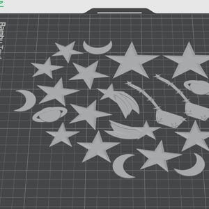 May include: A collection of gray star, crescent moon, and planet shapes cut from a textured sheet of material. The shapes are arranged in a loose circle on a black grid surface. The text "Bambu Textured PEI Plate" is visible in the upper left corner of the image.