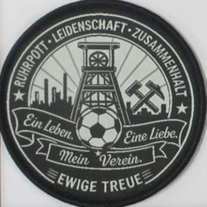 May include: A circular black and white embroidered patch featuring a central mining headframe, a soccer ball, and crossed hammers. The text reads Ruhrpott, Leidenschaft, Zusammenhalt, Ein Leben, Eine Liebe, Mein Verein, and Ewige Treue.