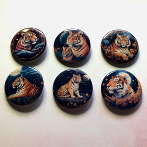 May include: Six circular pin-back buttons featuring detailed illustrations of tigers in various nocturnal settings. Each button displays a unique tiger portrait against a dark, starry background with moons, clouds, and floral elements in shades of orange, blue, and black.