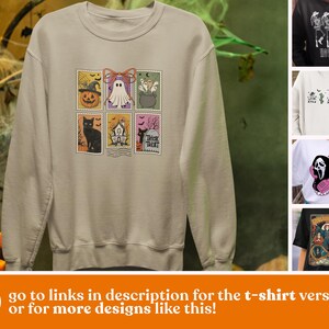 May include: Beige sweatshirt featuring a Halloween-themed stamp design with a pumpkin, ghost, cauldron, black cat, haunted house, and the words "Trick Treat." The text "go to links in description for the t-shirt version or for more designs like this!" is at the bottom.