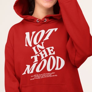 May include: Red hooded sweatshirt with white text that reads "NOT IN THE MOOD" and a smaller white text that reads "You did the best you could today. And that is good enough. Things usually turn out just perfectly."