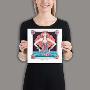 May include: A colorful illustration of the zodiac sign Scorpio. The image features a woman with red hair wearing a blue and pink swimsuit with a scorpion design. The background is black with pink stars and the text "SCORPIO OCTOBER 23 - NOVEMBER 21".