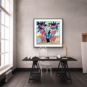 May include: A framed painting of a woman standing in a tree with pink antelopes surrounding her. The painting is set against a light blue background with green palm trees.