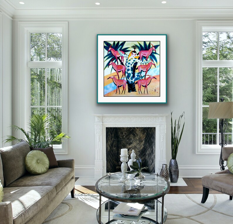 May include: A colorful painting of a woman in a green and white patterned dress standing on a tree trunk surrounded by pink and white deer. The painting is framed in a teal frame and hanging on a white wall.