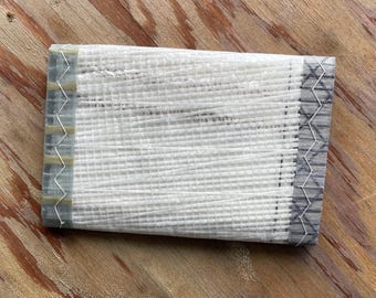 Cartera de lona de tres pliegues reutilizada y remanente