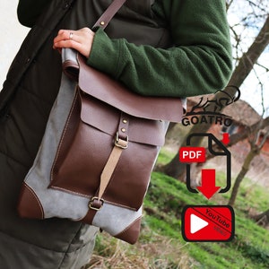 May include: A brown leather and canvas messenger bag with a strap and buckle. The bag is being held by a person wearing a green sweater. The image also includes text that says "GOATRO" and "PDF".