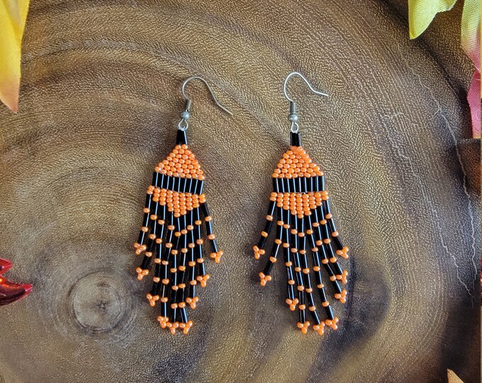 Handmade, beaded, 9 strand, 3.25" long with a 2.5" dangle, short multi-length Orange and Black fringed dangle earring for pierced ears.