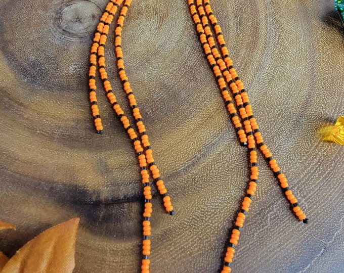 Long Orange and Black, 3 strand, multi-length, handmade, beaded, earrings are the perfect for casual or dress. by Be Dazzled Earrings.