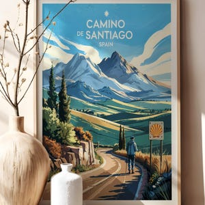 May include: A vintage-style poster with a blue sky and white clouds. The poster features a mountain range with a road leading through it. The text on the poster reads "Camino de Santiago, Spain".