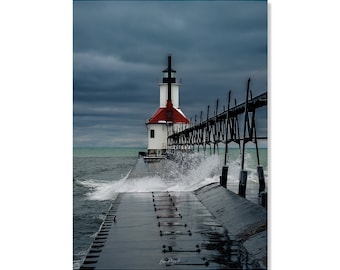 May include: A white lighthouse with a red roof stands on a pier with a black railing. Waves crash against the pier, creating a dramatic scene.