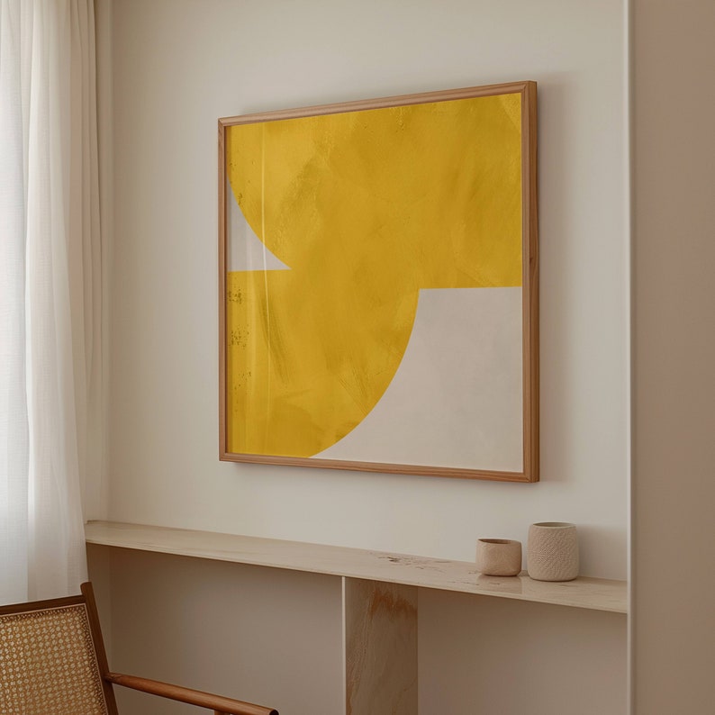 May include: A framed abstract painting with a yellow and white geometric design. The painting is hanging on a white wall above a shelf with two small ceramic pots.