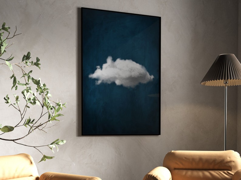 May include: A framed print of a single white cloud against a dark blue background.