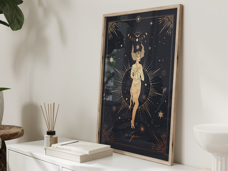 May include: A gold and black framed print with a celestial design featuring a woman with a crown of stars and the word "Scorpio" at the bottom.