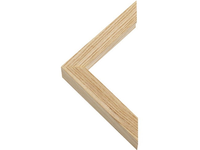 May include: Close-up of a corner of a natural wood picture frame. The frame is made of solid wood with a light brown finish.
