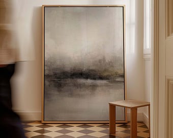 May include: Large framed abstract landscape art in neutral tones of gray, black, and beige. The artwork is displayed in a room with a small wooden side table and a checkered floor. The painting has a minimalist style.