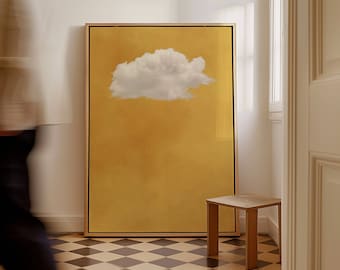 May include: A framed print of a white cloud against a yellow background. The print is hanging on a white wall in a room with a checkered floor and a small wooden stool.