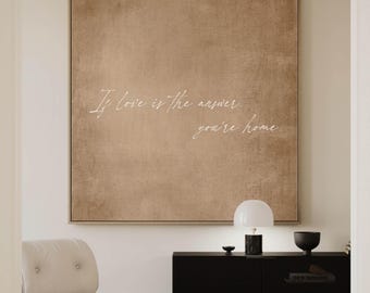 May include: A brown canvas wall art with the text "If love is the answer you're home" in white script.