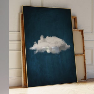May include: A framed canvas print with a single white cloud on a dark blue background. The frame is gold.