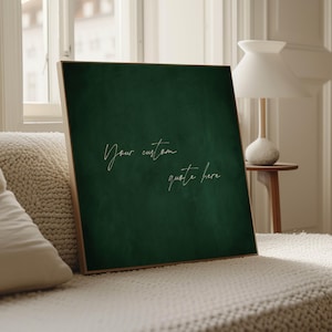May include: A framed square canvas with a deep green textured background. The text "Your custom quote here" is written in a delicate, cursive font. The frame is a light wood color, and the canvas is displayed on a white surface.