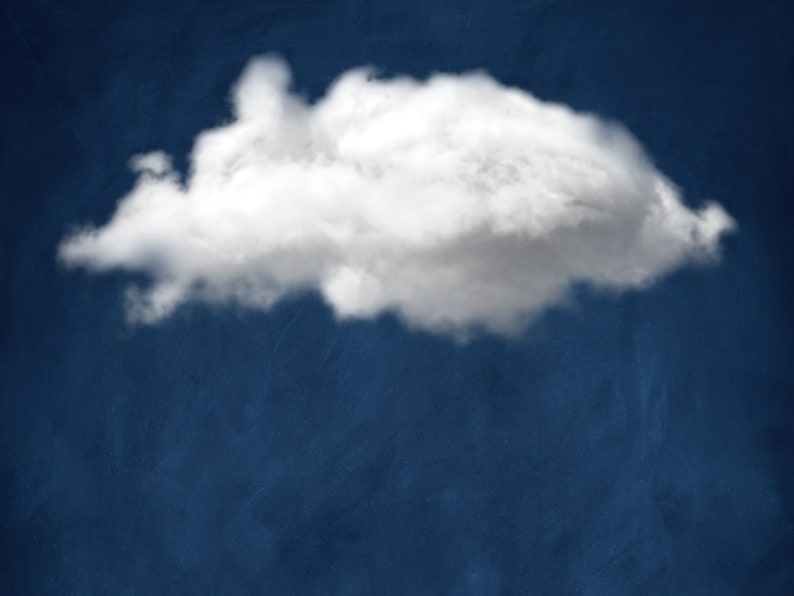 Op de afbeelding: Een enkele, pluizige witte wolk tegen een diepblauwe lucht.