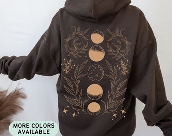 May include: A brown hoodie with a graphic of four moons in different phases surrounded by leaves and stars. The graphic is in a light brown color.