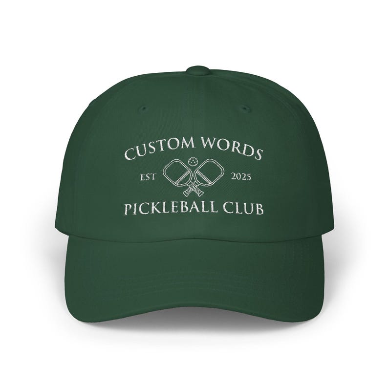 Custom pickleball hat embroidered with your team of clubs name. Features pickle ball paddles and the year.