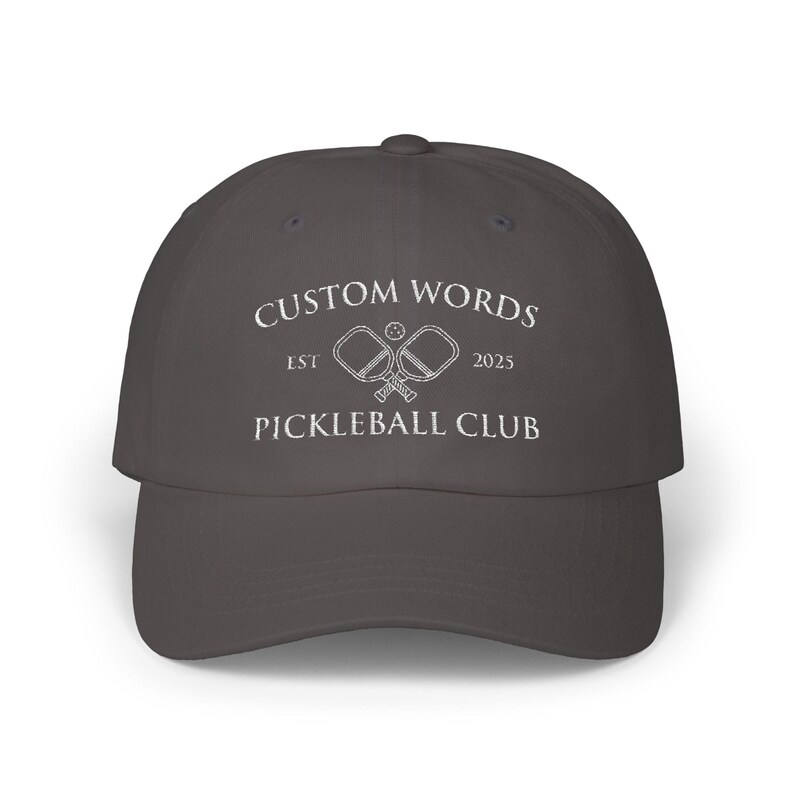Custom pickleball hat embroidered with your team of clubs name. Features pickle ball paddles and the year.