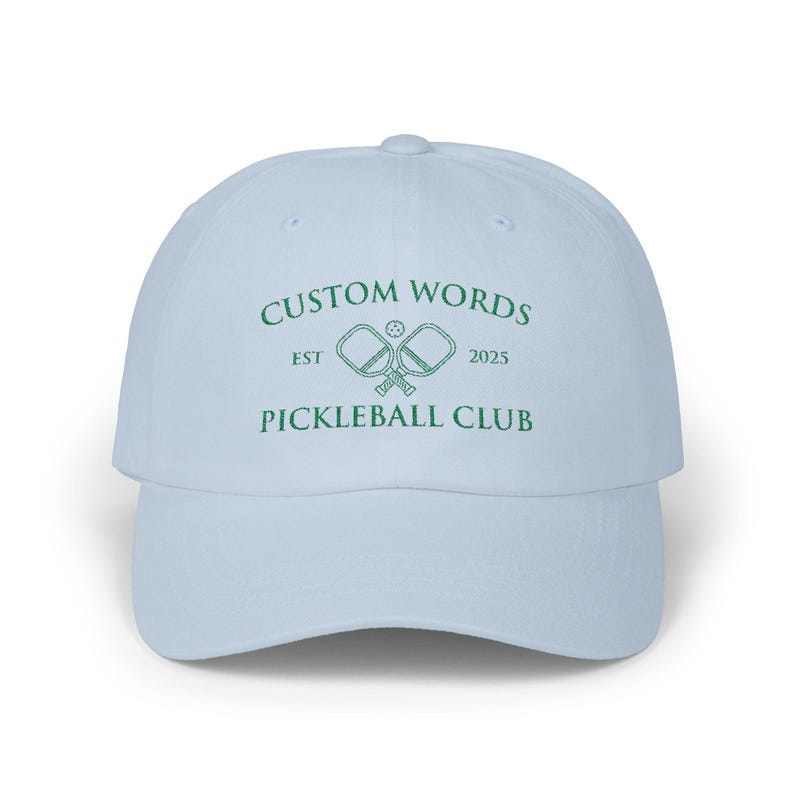 Custom pickleball hat embroidered with your team of clubs name. Features pickle ball paddles and the year.