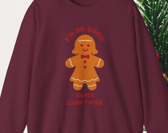 May include: Burgundy sweatshirt with a gingerbread person graphic. The gingerbread person has a bow tie and a dress. The text on the sweatshirt says "I'm so good" and "Santa came twice".