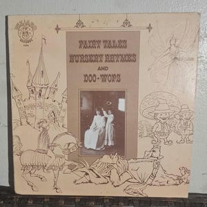 May include: Vintage vinyl record album cover with illustrations and text. The cover features a drawing of a castle, a unicorn, and other whimsical figures. The album title is "Fairy Tales, Nursery Rhymes and Doo-Wops."