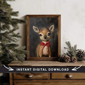May include: A digital print of a painting featuring a fawn with a red bow. The fawn is looking directly at the viewer with a sweet expression. The background is a dark blue-grey color. The print is framed in a rustic wooden frame.